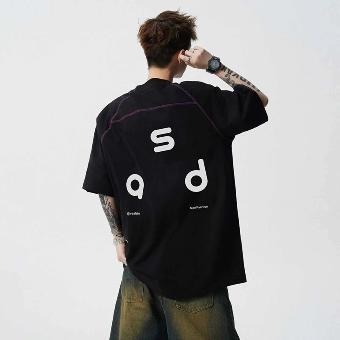 Loose fit black cotton t-shirt with letter print graphic on front, short sleeves, and round neck.