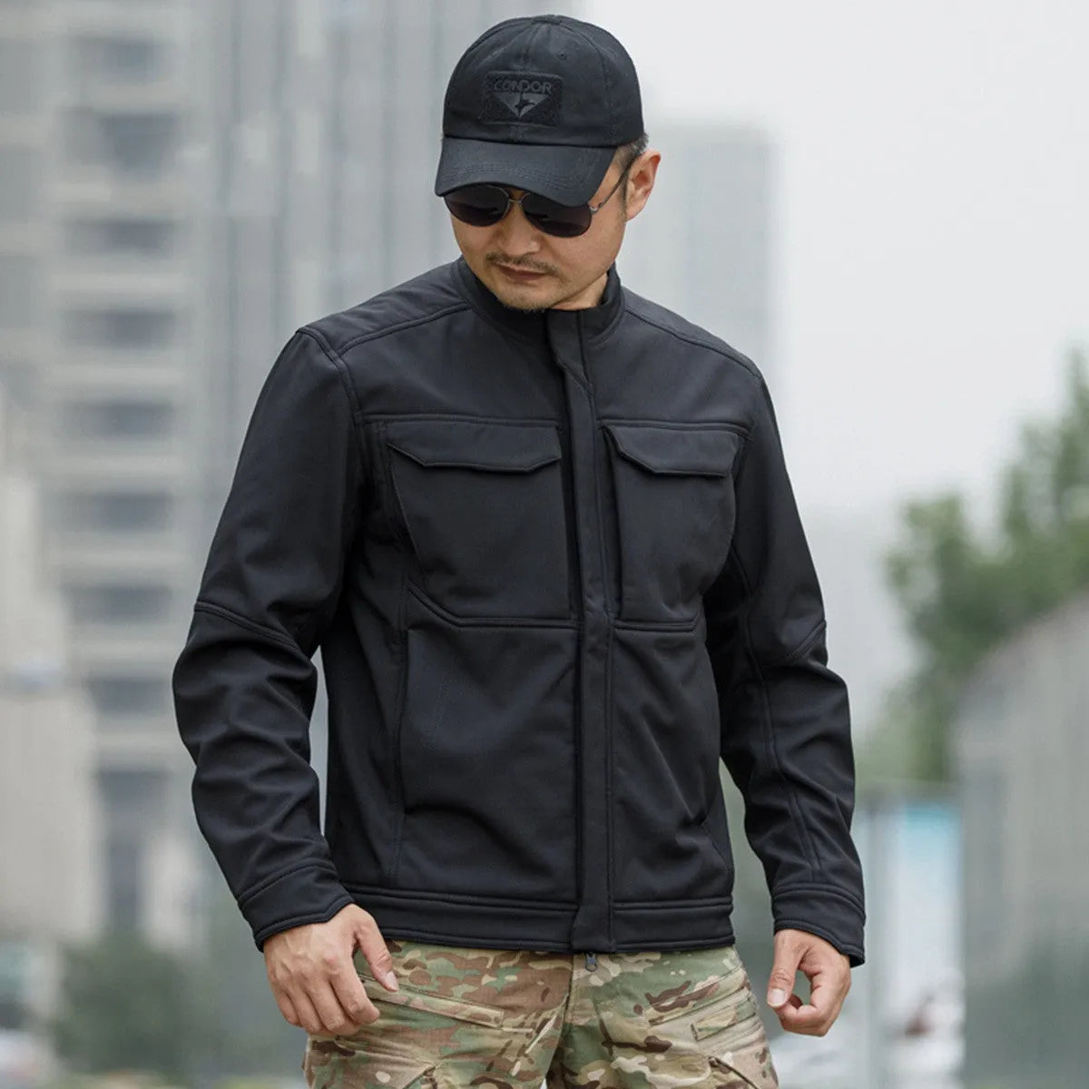 A black soft shell jacket for mountaineering and camping, shown in a cardigan style.