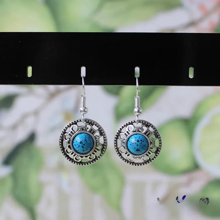 Handmade Tibetan silver earrings with turquoise geometric flower disk design in Miao ethnic style