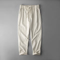 Men's solid colour linen casual trousers in mid-waist fit shown in grey, navy, or apricot.