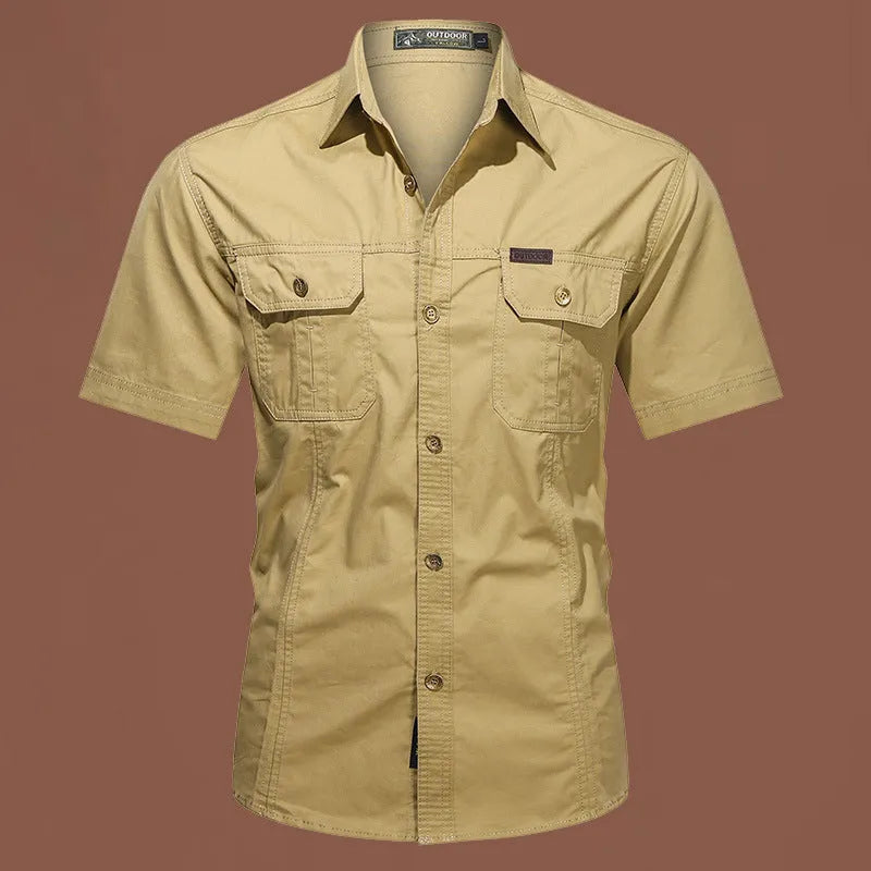 Men's army green cotton work shirt with short sleeves and non-iron finish on a hanger.