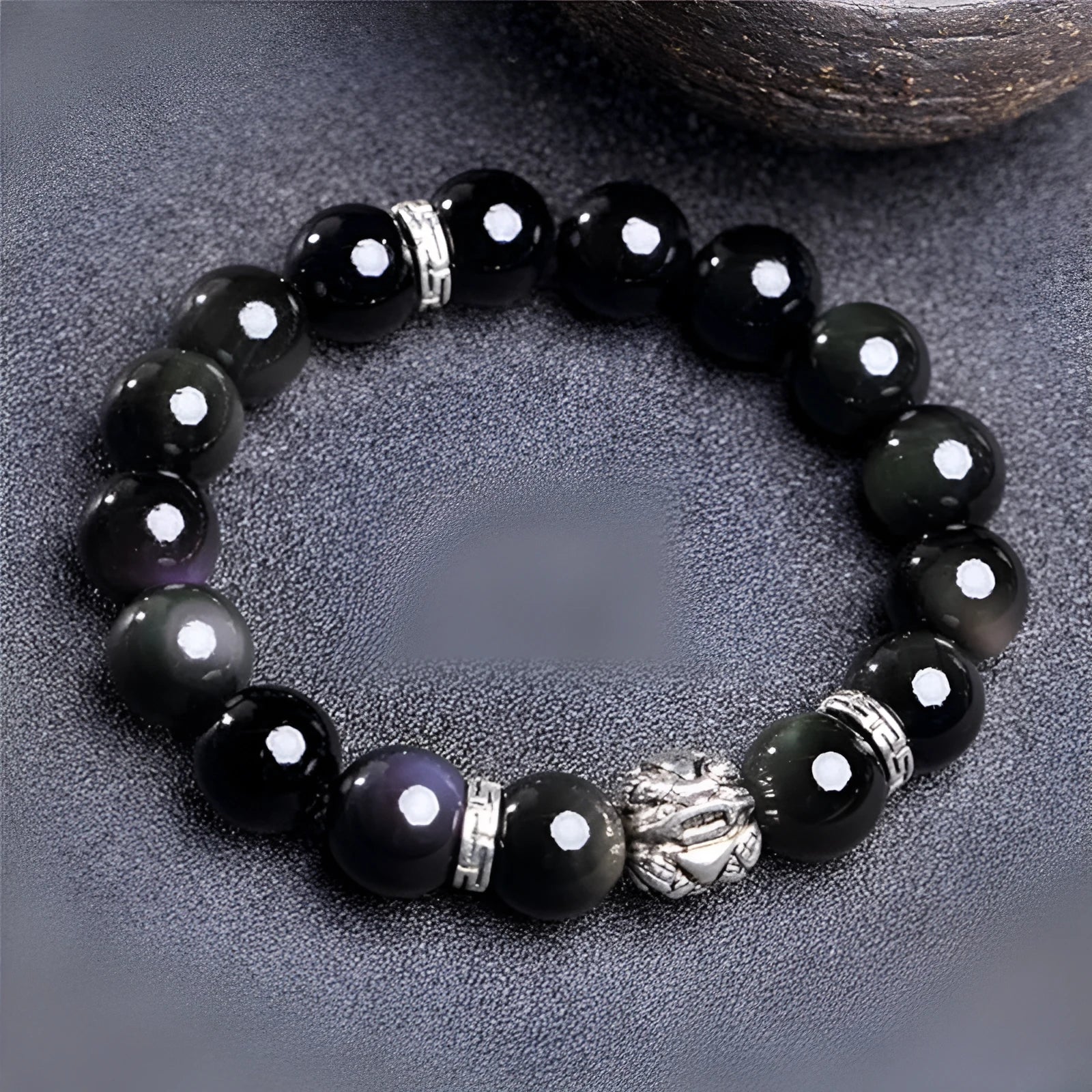 Obsidian bracelet with natural cloud pattern and silver clasp shown in male 12mm and female 10mm sizes.