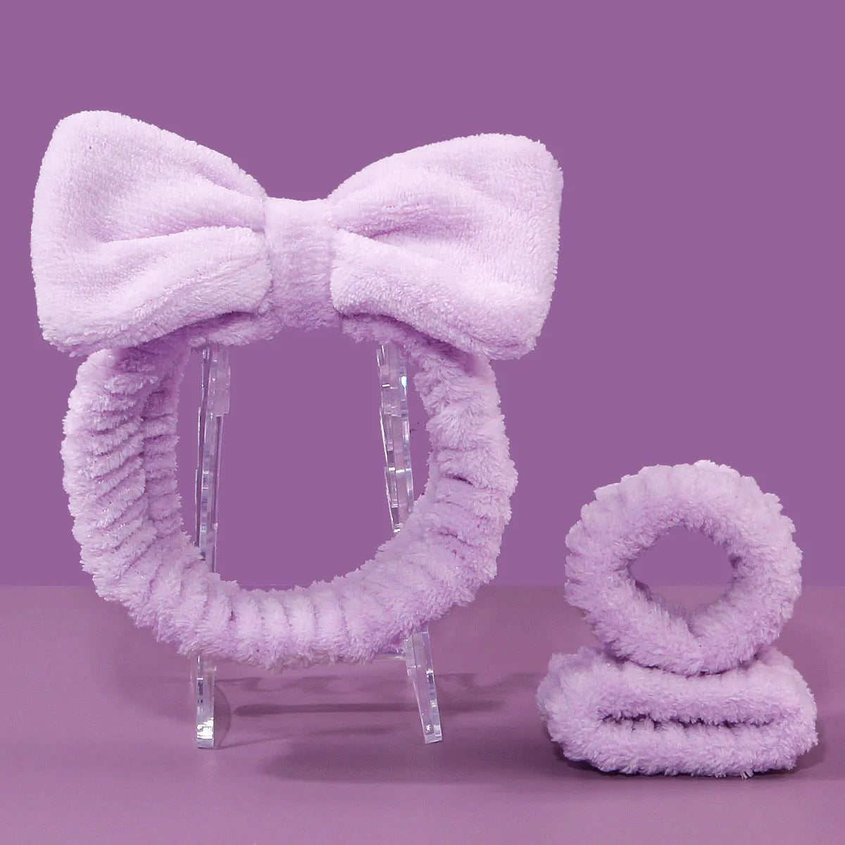 Facial brush set with coral fleece hair band and four nylon brush heads in purple grey white pink colours