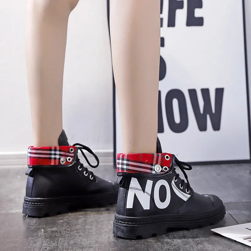 Women's high-top canvas short boots with cross straps and buckles in black, side view