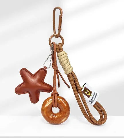 Handmade soda bread design handbag pendant with brown star carrying strap and baking varnish finish