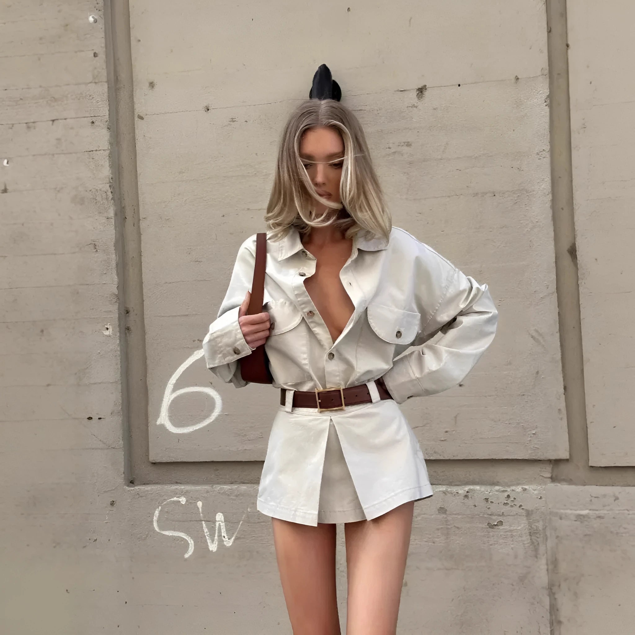 Grey long sleeve button front shirt dress with low waist and fake pocket details on a model