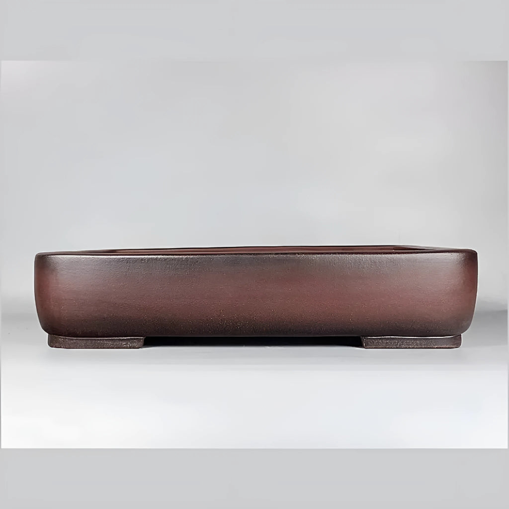 Handmade rectangular purple clay flower pot on a tabletop
