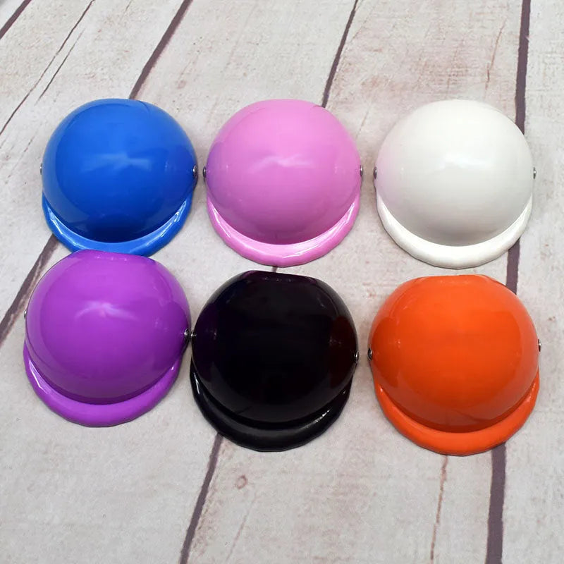 Plastic dog motorcycle helmet in various colours showing three size options
