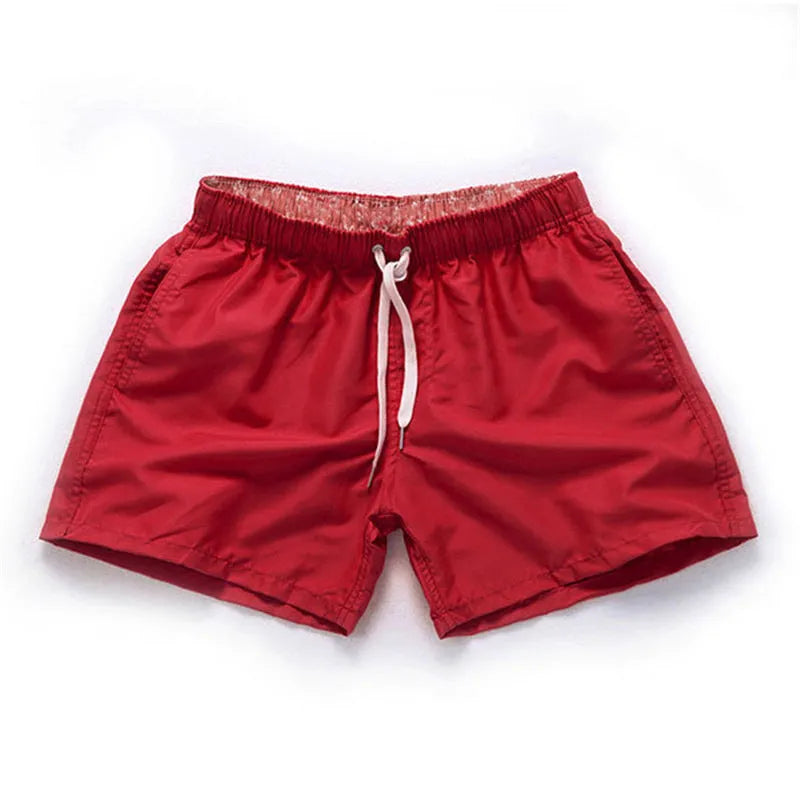 Men's straight-leg polyester beach shorts in multiple colours on a size chart showing S to 4XL.