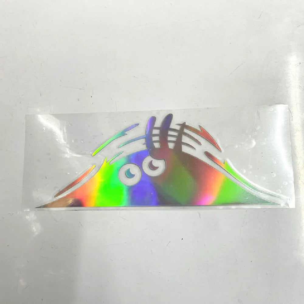 Self adhesive body sticker showing a colourful smiley face design, measuring 19cm by 7cm.