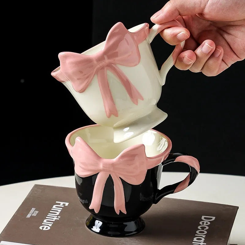 Ceramic mug with a cute girl heart bow design in black pink and white powder colours.