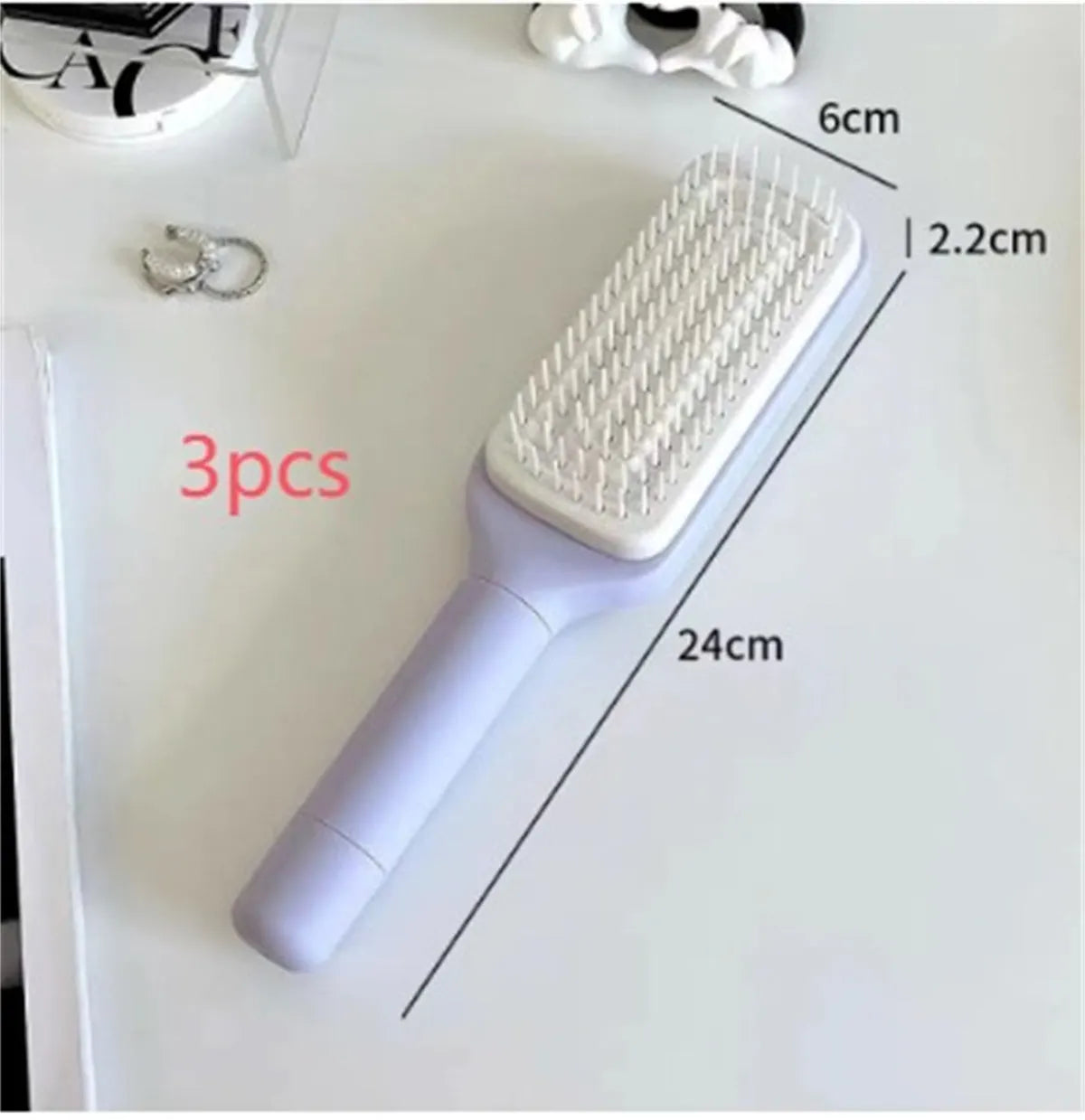 Roland purple self-cleaning hair brush with rotating handle and anti-static teeth
