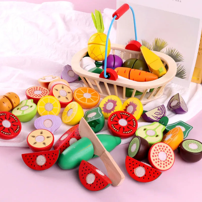 Wooden magnetic play fruit and vegetable cutting toy set on a table, including apple, banana, carrot, and more.