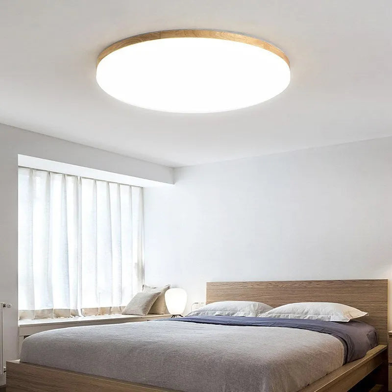 Japanese minimalist ceiling lamp with wood art body and acrylic shade in three sizes.