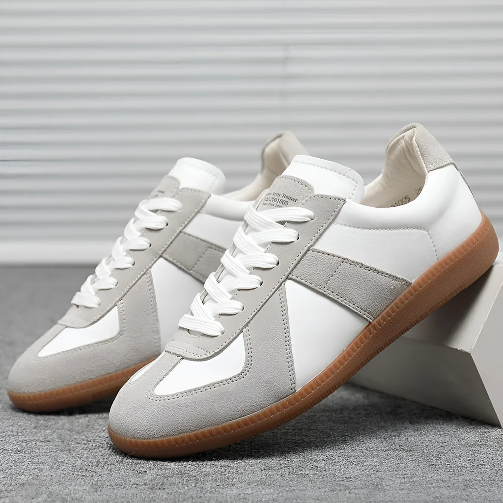 White Japanese-style retro low-top sneakers with round toe and flat rubber sole on a solid background.