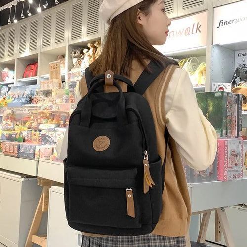 Black retro-style Oxford cloth backpack with curved shoulder straps.