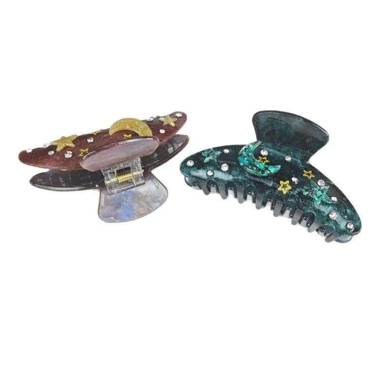 Oversized star barrette hair clip with celestial star moon design on white background