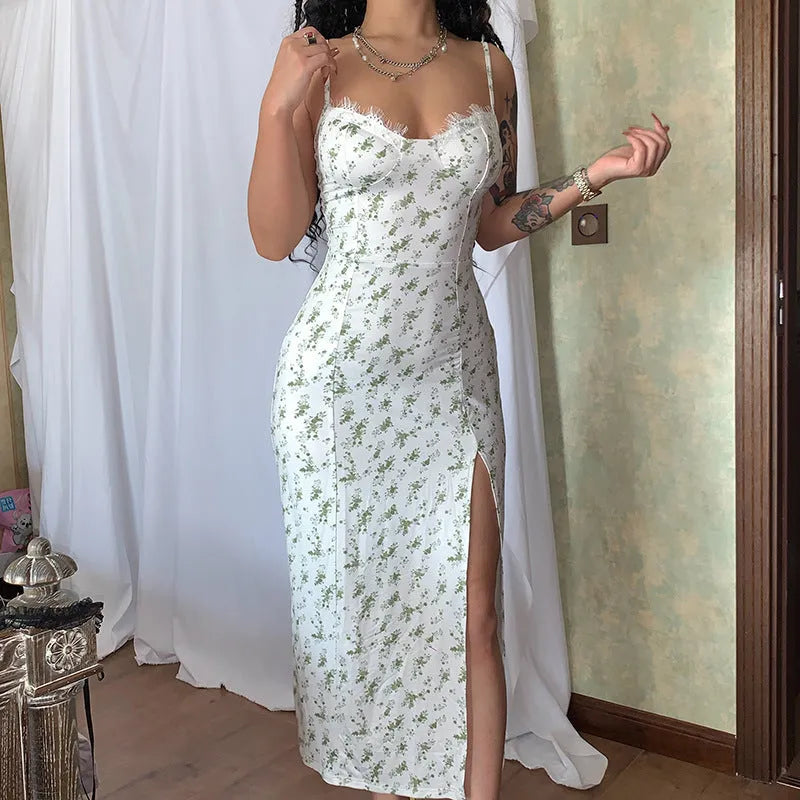 Women's blue lace flower print long dress with thigh slit and black suspender straps.