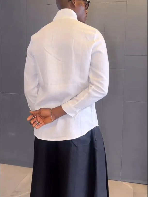 Women's white asymmetric long sleeve shirt and black pleated trousers co-ord set