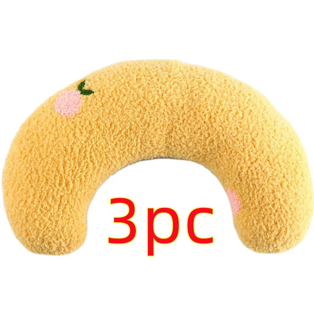 White U-shaped plush pet pillow for a cat, showing its donut shape and quilted texture.