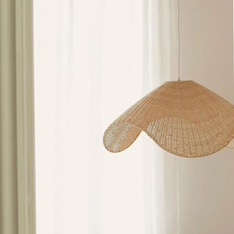 Handmade bamboo and rattan pendant ceiling lamp with a woven willow shade in warm white light.