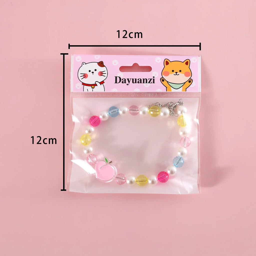 Colourful plastic bead pet necklace in peach, rainbow, and small flower designs for cats and dogs