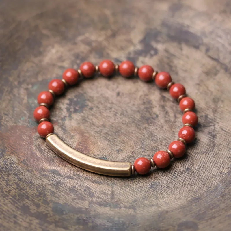 Layered ethnic bracelet with natural stones and brass components on a wrist