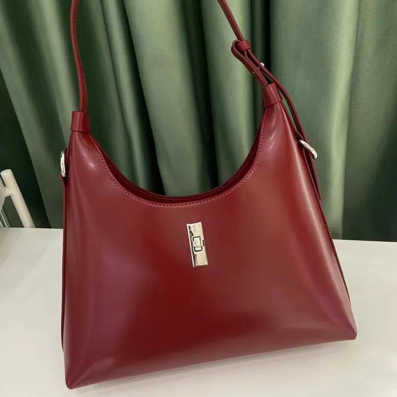 Soft genuine leather crossbody shoulder bag in a dumpling shape, shown in one of six available colours.