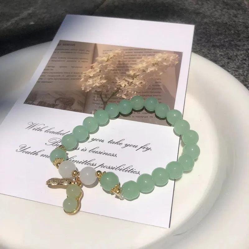 Chinese style glass bead bracelet with bamboo leaf design and manual craftsmanship details.