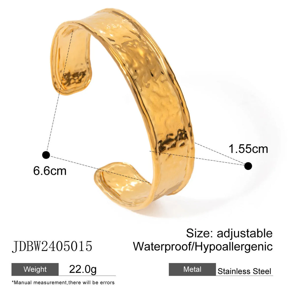 Silver wing design adjustable ring on hand showing opening mechanism