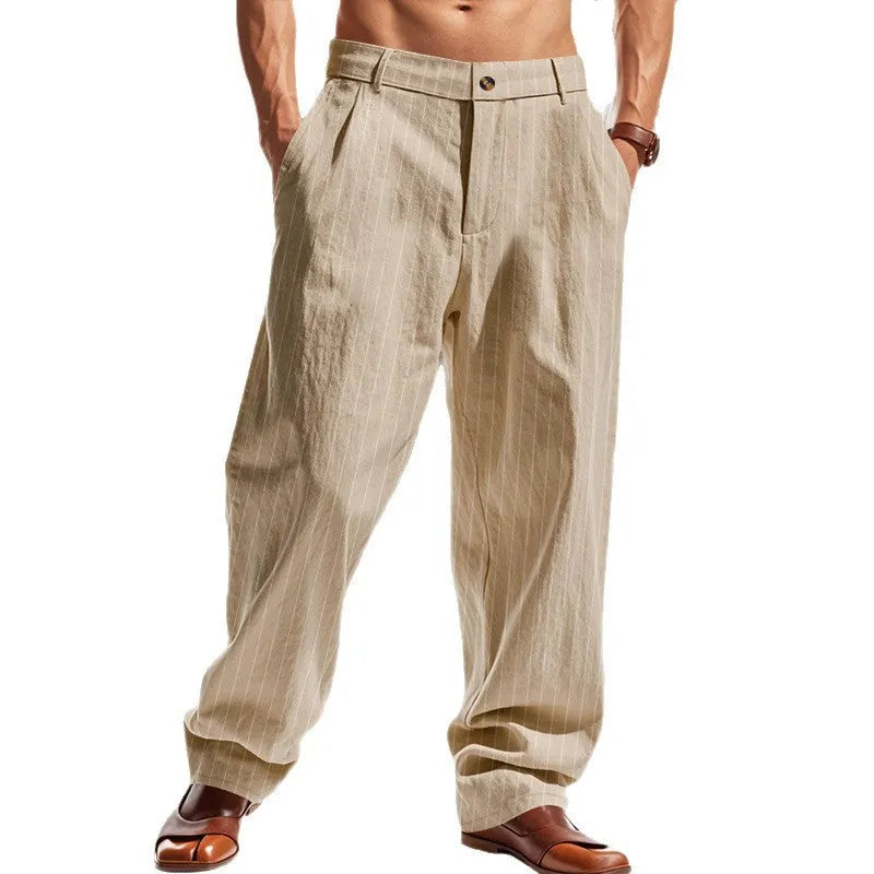 Man wearing straight-cut, high-waisted linen trousers with a wide leg and striped pattern in a light colour.