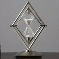 Glass sand timer with zinc alloy metal ornaments showing bronze or silver finish with white or black sand