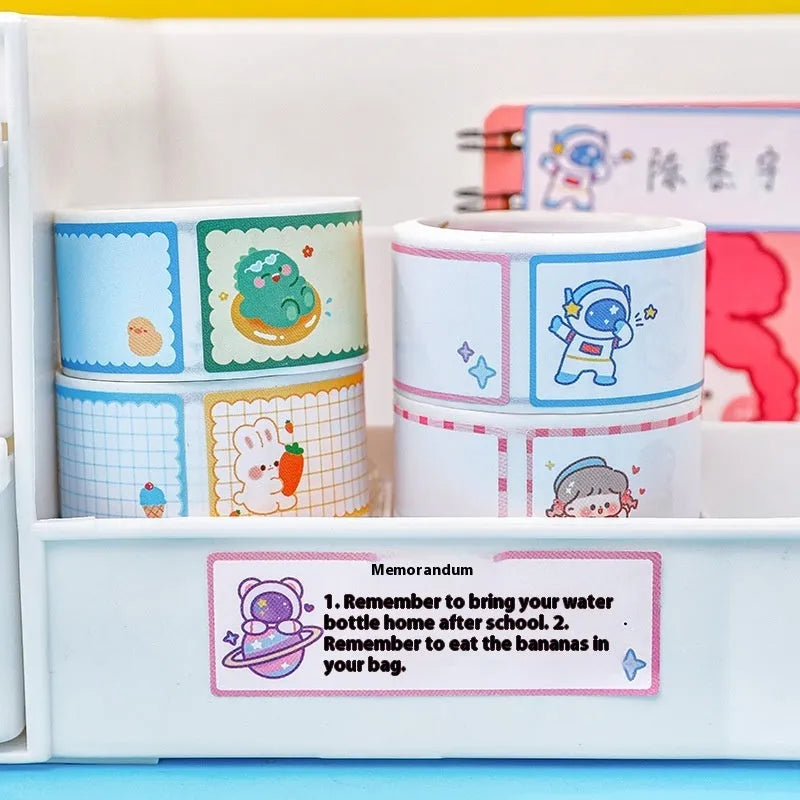 Roll of cartoon-themed adhesive name tape stickers showing dinosaur, astronaut, rabbit, and girl designs.