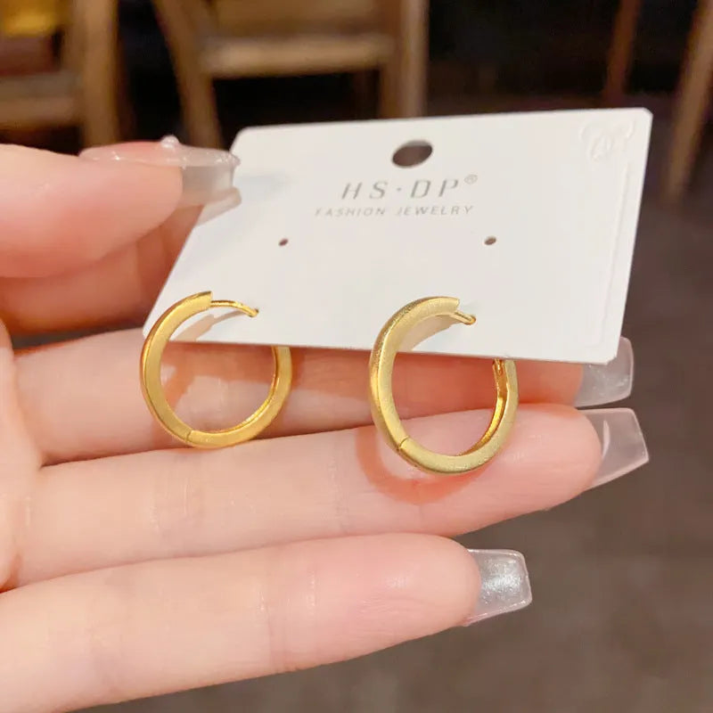 A pair of round geometric clip-on earrings for women in gold or silver plating.