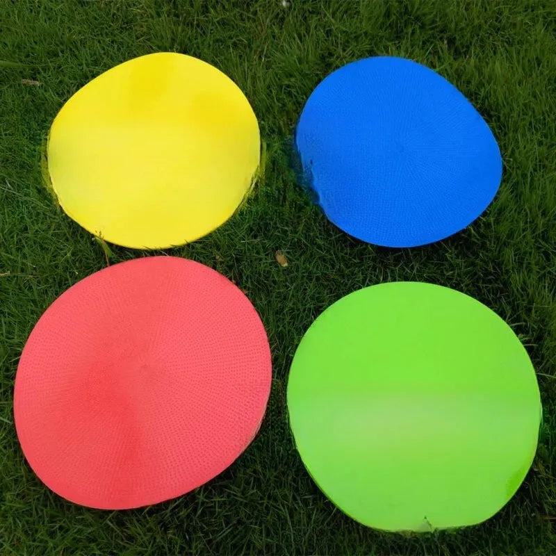 Soft coloured football training marker disc on grass field for target practice
