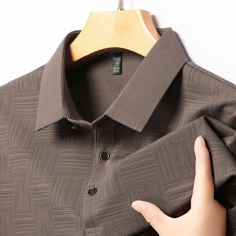 Man wearing a slim fit lapel T-shirt in a chemical fibre blend, available in multiple colours.