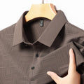 Man wearing a slim fit lapel T-shirt in a chemical fibre blend, available in multiple colours.