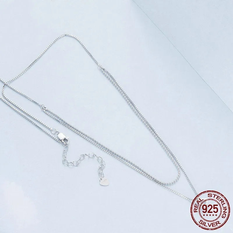 Close-up of a women's double-layer pearl chain sterling silver necklace with a matching pendant.