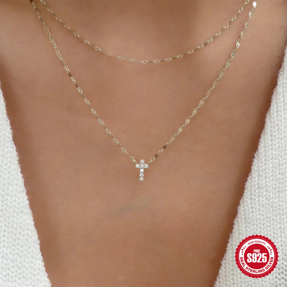 Sterling silver double layer cross pendant with twin diamonds on a clavicle chain.