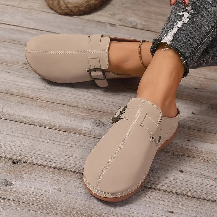 Women's casual wedge slippers in various colours with a cloth upper and rubber sole.