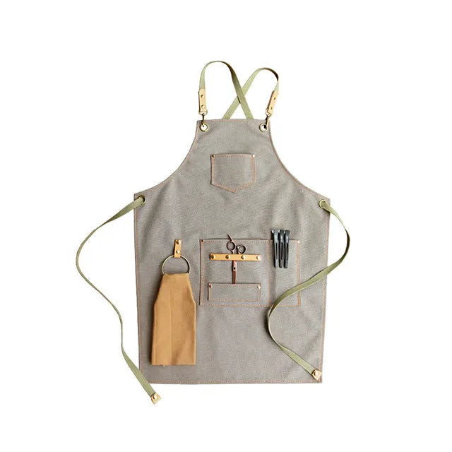 Canvas apron with cross-back straps in camel colour.