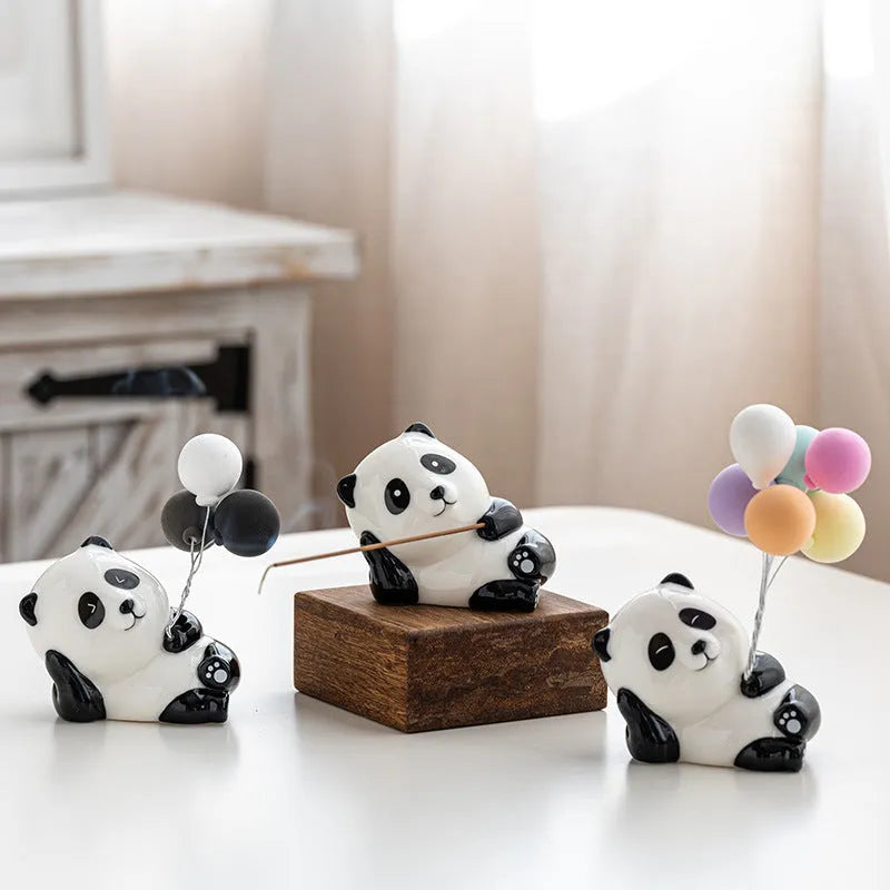 Ceramic panda incense holder with open eyes placed on a desk for aromatherapy use, 8.5cm long