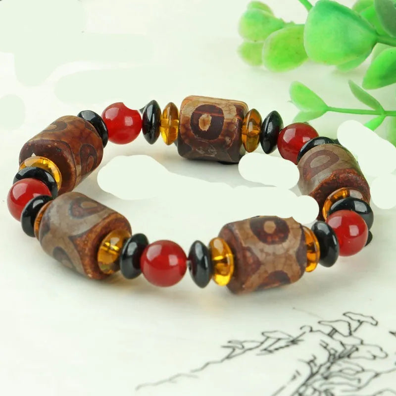 Distressed agate Tibet beads bracelet with three eye dzi design and polished stone beads
