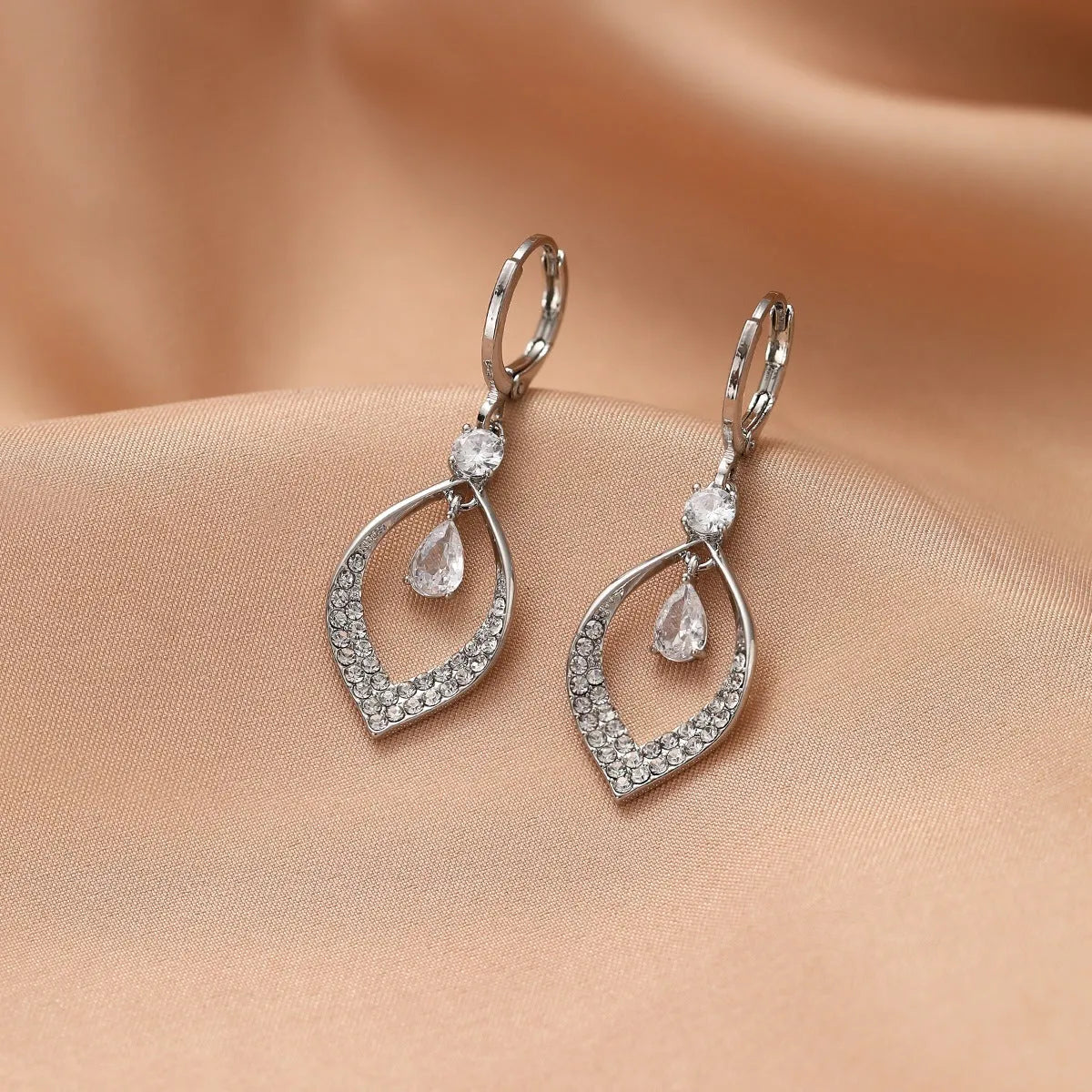 Women's gold and silver water drop tassel earrings made from zircon and copper.