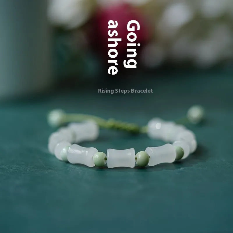 Chinese style glass bead bracelet with bamboo leaf design and manual craftsmanship details.