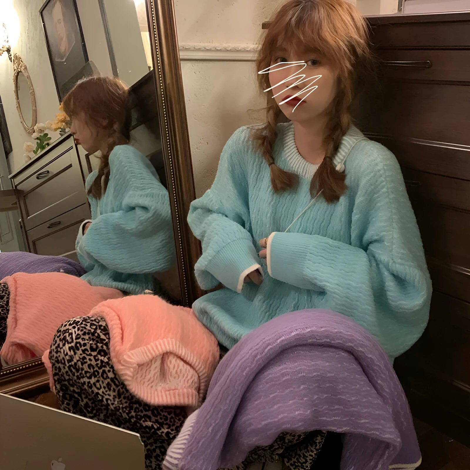 A loose-fitting women's pullover sweater in a solid colour, shown in a lake blue hue with long sleeves.
