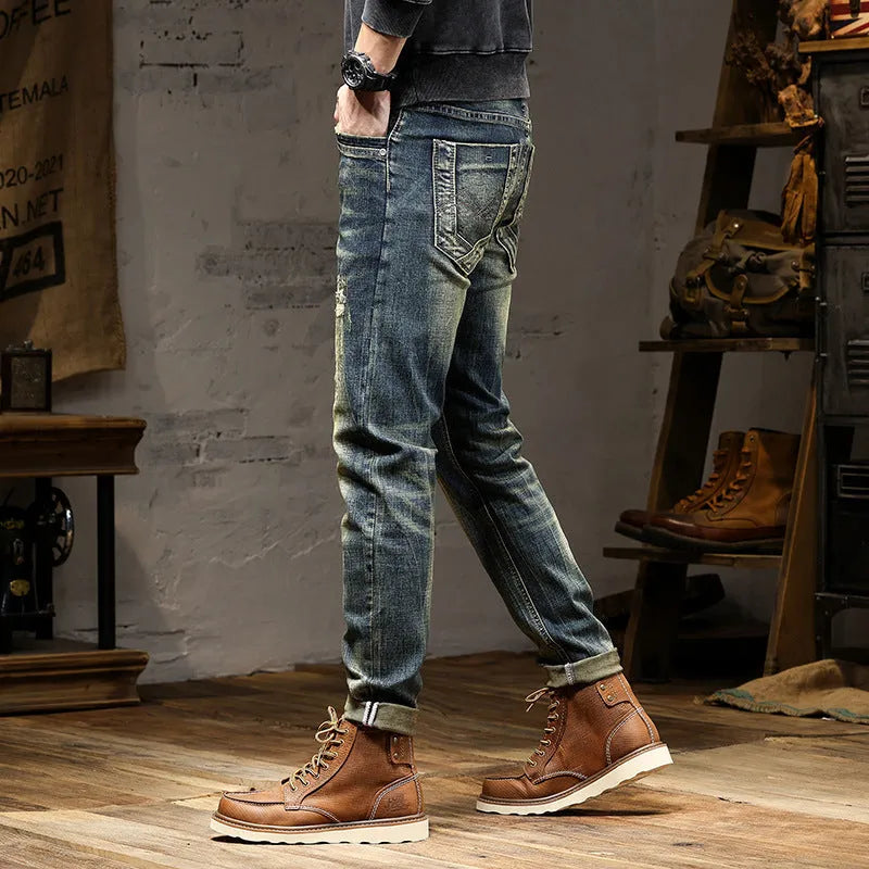 Men's slim-fit jeans in a retro colour with a zip fly, shown laid flat.