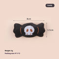 Plush cat teaser toy with candy, eyes and skull attachments on handheld wand