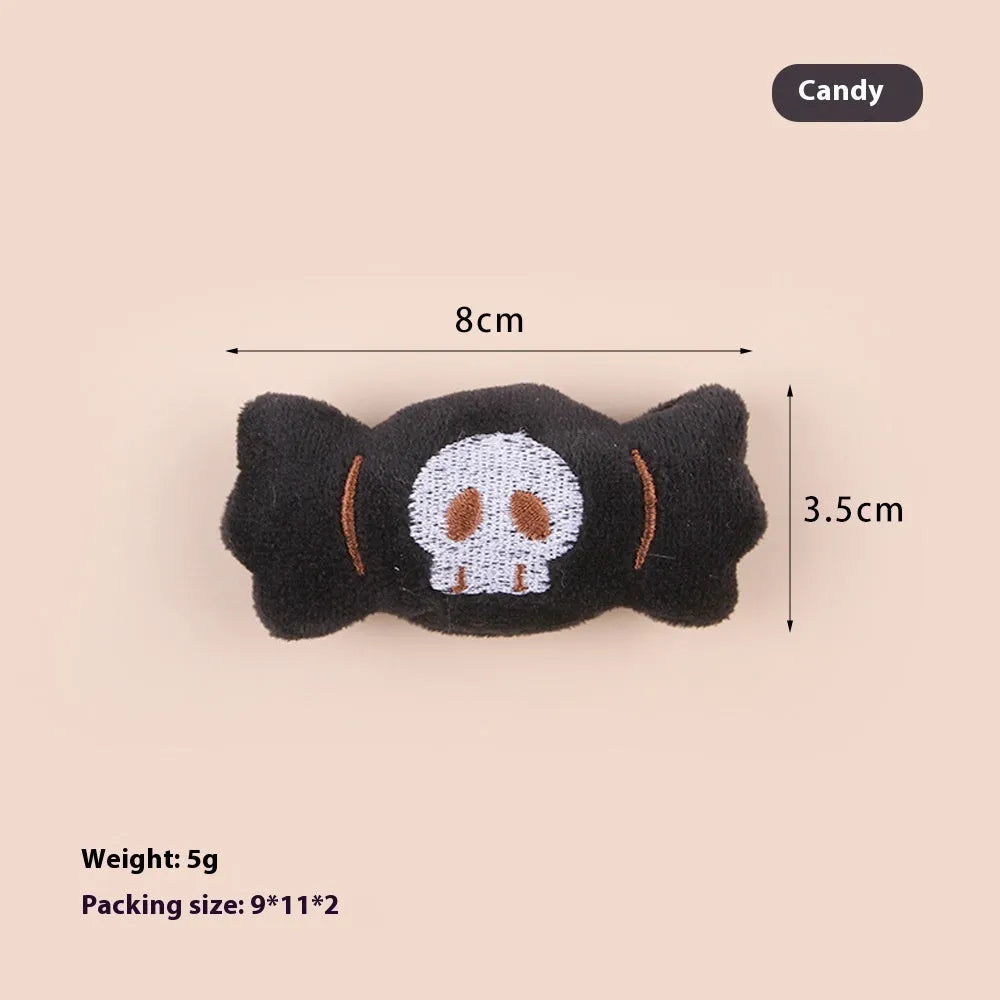 Plush cat teaser toy with candy, eyes and skull attachments on handheld wand