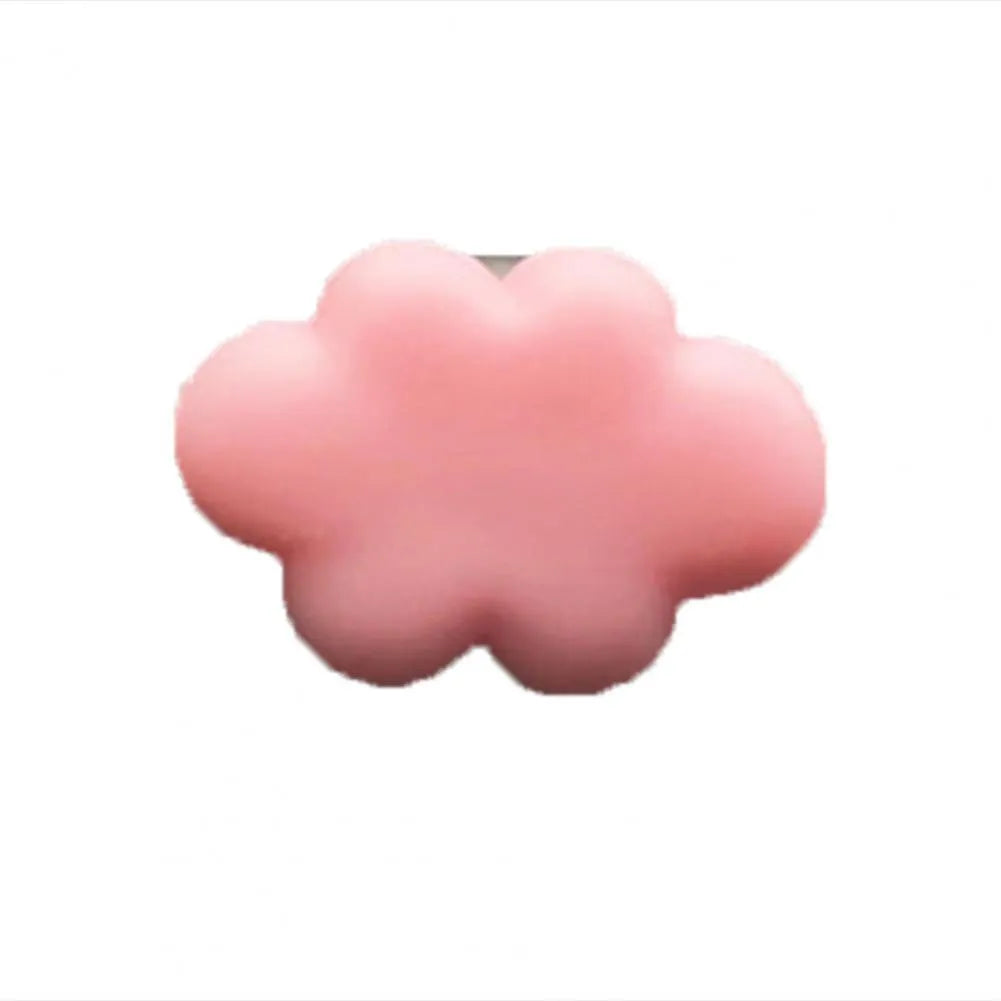 Small colourful resin car fragrance clip shown in multiple colours on a car air vent.